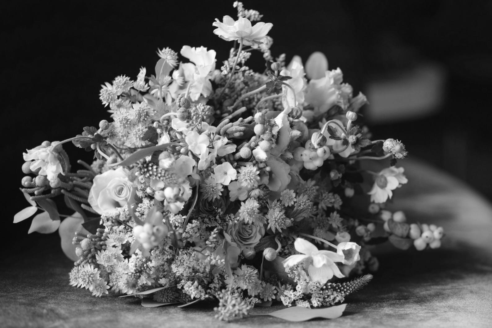 Fresh flower arrangement being carefully prepared with attention to detail